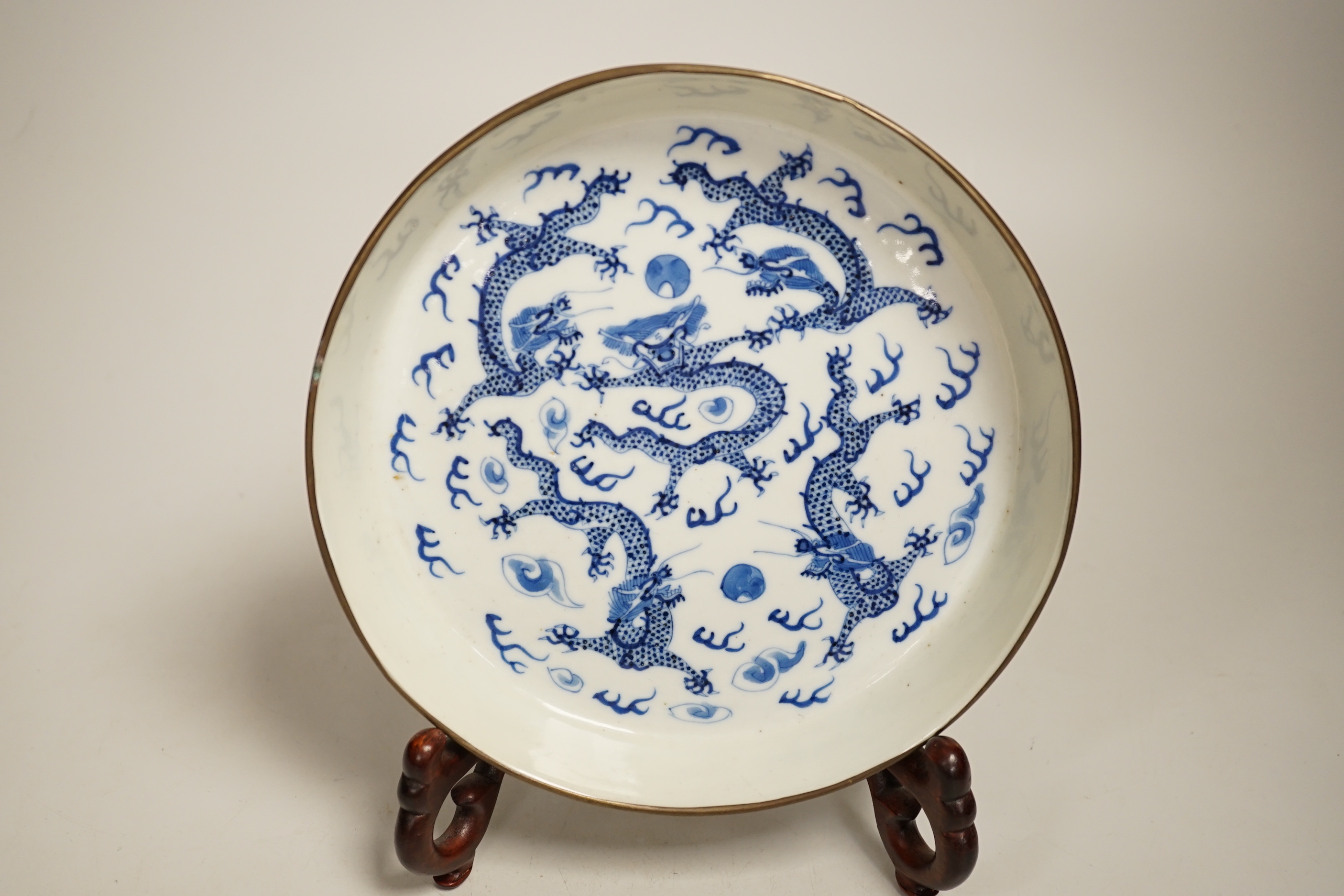 A 19th century Chinese blue and white ‘dragon’ dish and stand 18.5cm diameter